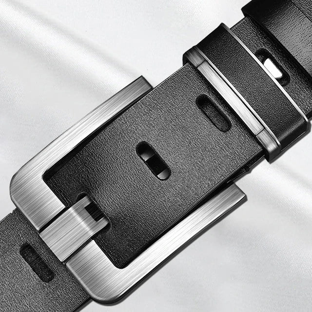 Close-up of a black leather belt with silver buckle on a light gray background